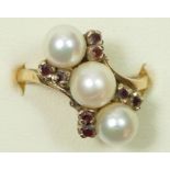 A 9ct gold three cultured pearl and garnet crossover ring, N 1/2, 4.5gm