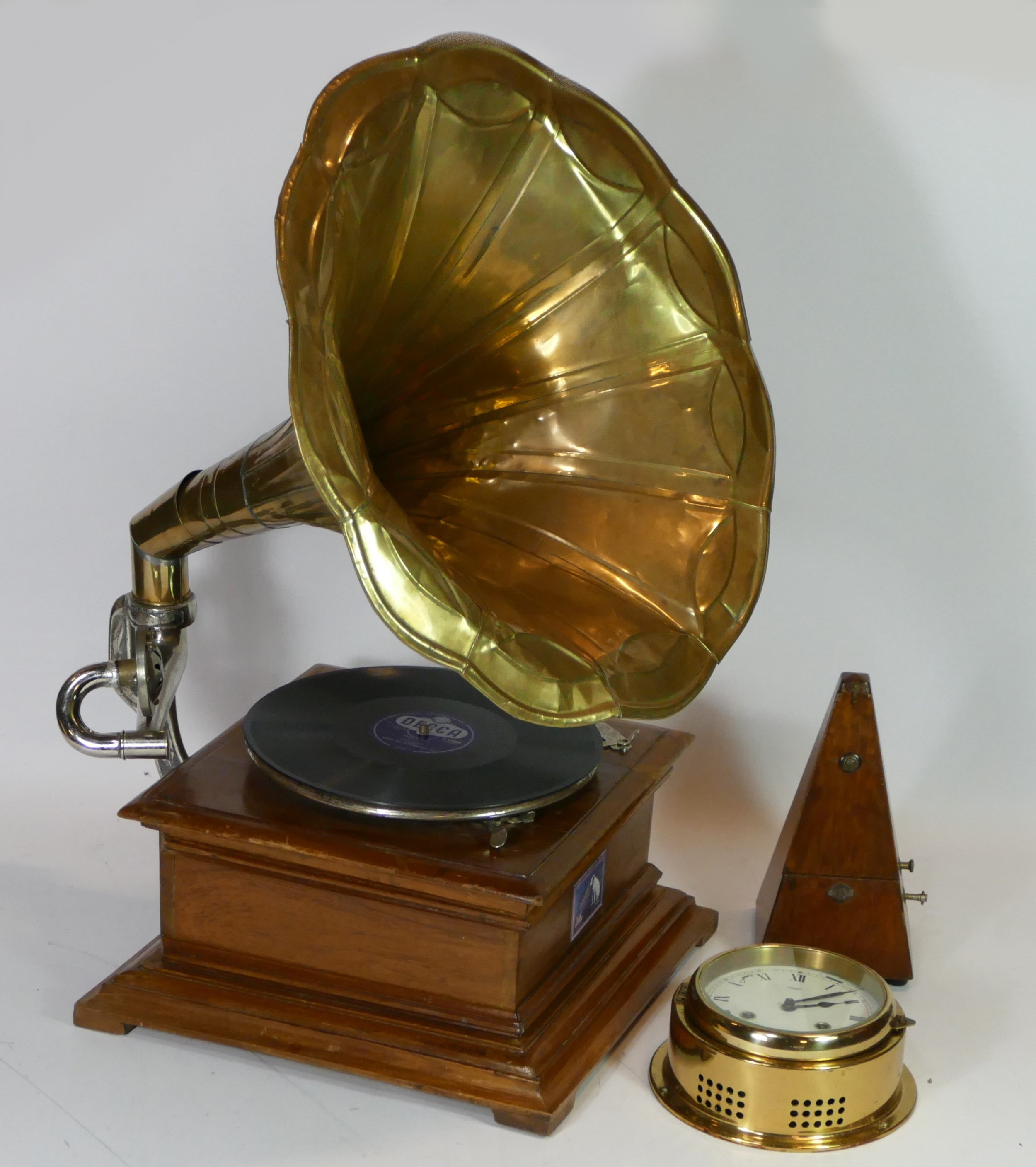 A reproduction His Masters Voice gramophone, together with a metronome and a Talamex ships bulk head