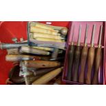 A collection of wood working tools, including planes, hand drills, chisels and others, including