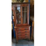 An Edwardian mahogany small bookcase over four long drawers, 61 x 40 x 151.