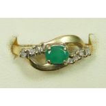 A 9ct gold emerald and diamond crossover ring, O, 1.6gm