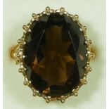 A 9ct gold citrine dress ring, London 1992, claw set with an oval mixed cut stone, 20 x 15mm, ornate