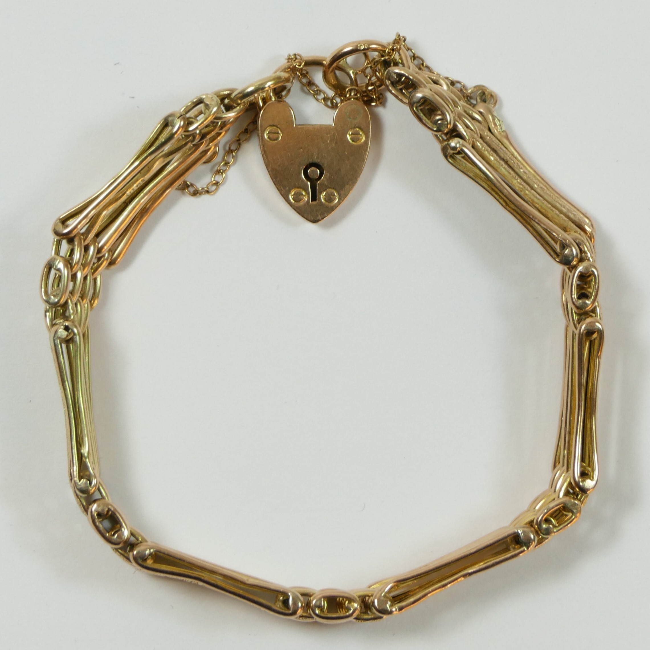 An Edwardian 9ct rose gold night and day gate link bracelet, padlock clasp, 10.2gm