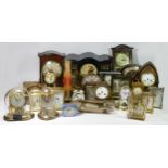 A collection of manual wind and quartz clocks, to include anniversary, carriage and mantel examples.