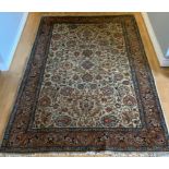 A Persian rug with beige field 310cm x 200cm