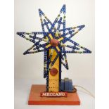 A Meccano shop display, twin star, illuminated and spinning stars, yellow and blue, powered, on a