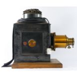 An unbranded magic lantern, with lens, converted to electric