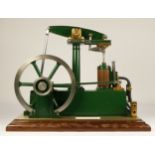 A Stuart Turner stationery beam engine comprising of green body with vertical single cylinder engine