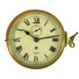 A Smiths Empire brass 15cm bulkhead clock, with subsidiary seconds dial, key