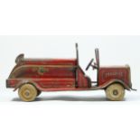 A vintage red painted metal fire engine, probably American, white rubber tyres, lacking ladder,