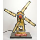 A Meccano shop display, windmill, illuminated and spinning blades, yellow and silver, powered, on