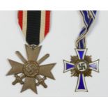 A WWII German bronze Mothers Cross with long ribbon and a Merit Cross with swords (2)