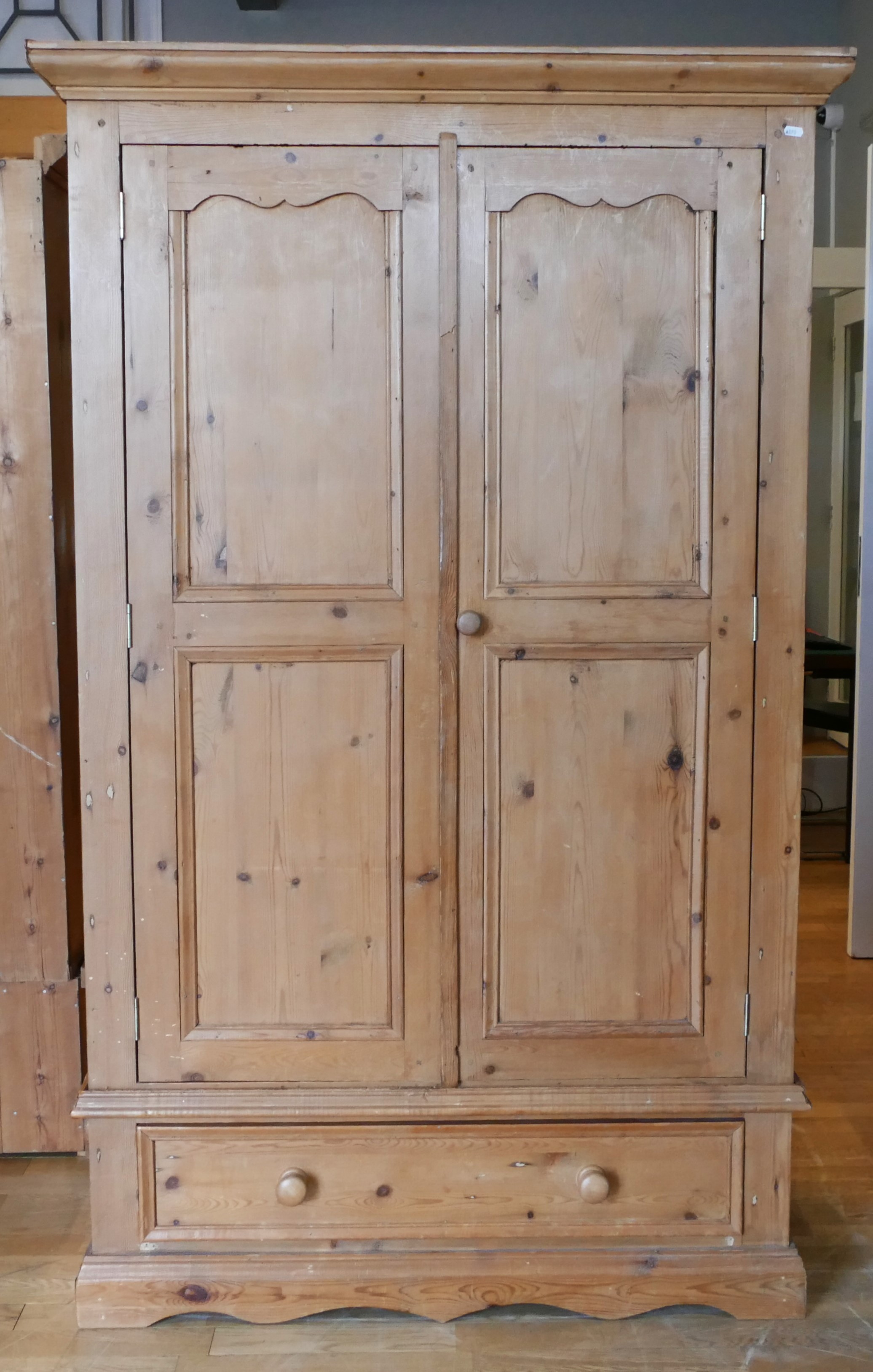 A modern rustic pine single wardrobe, twin doors with single long drawer below raised on a - Image 2 of 2