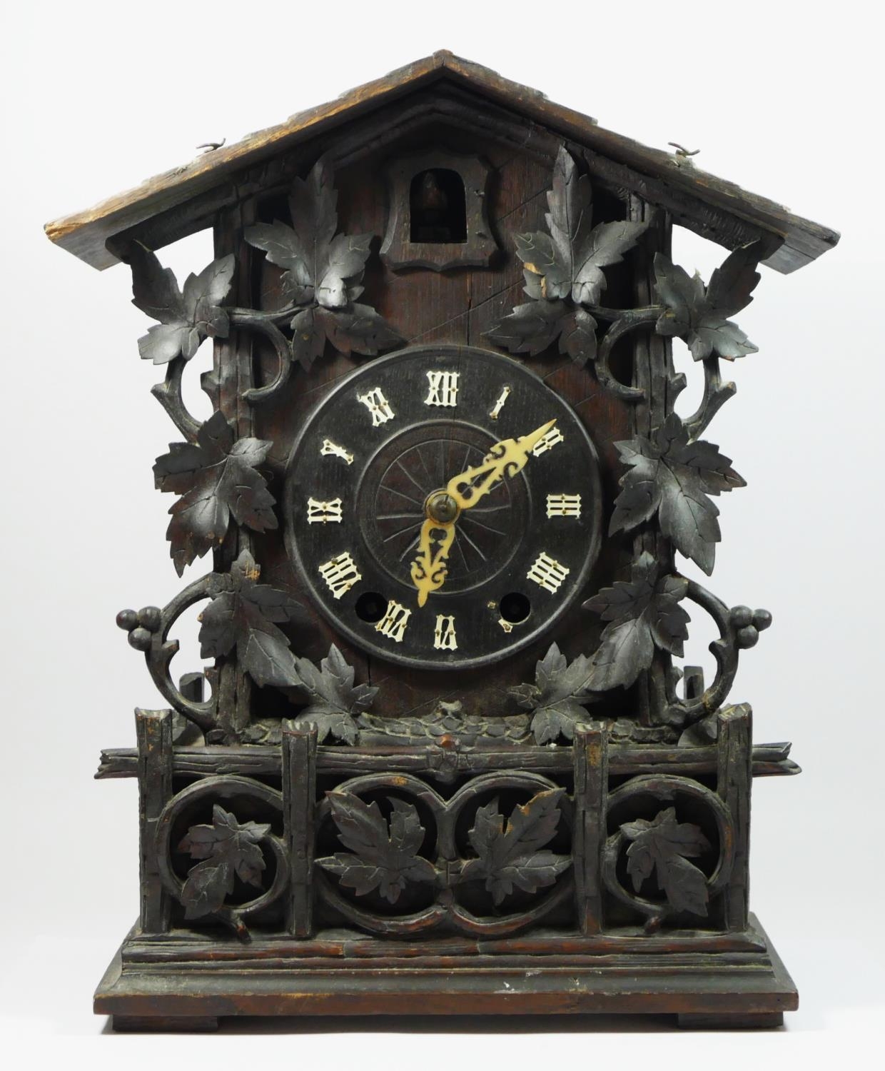 A late 19th/early 20th century Black Forest bracket cuckoo clock, the circular dial bearing roman