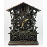 A late 19th/early 20th century Black Forest bracket cuckoo clock, the circular dial bearing roman