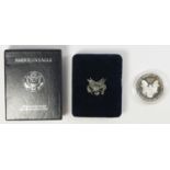 A 1997 silver proof American Eagle coin, presentation case and box.