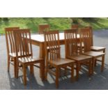 A modern light solid oak refectory dining table together with a set of eight dining chairs and a