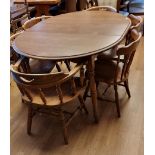 A light wood circular dining table, extendable with one leaf, 142cm x 110cm x 77cm, together with