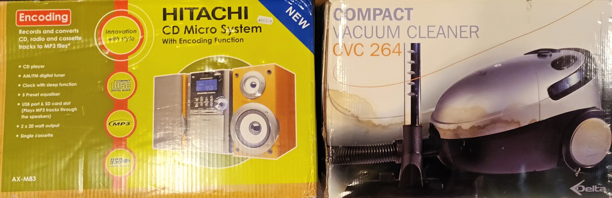 An Hitachi micro hi fi system AX-M83 (boxed) together with a Delta compact vacuum cleaner CVC 264 (