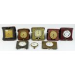 A collection of eight early 20th century traveling alarm clocks, having 8 day movements. (8)