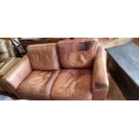 A tan leather two seater sofa, 170 x 95 x 83cm.
