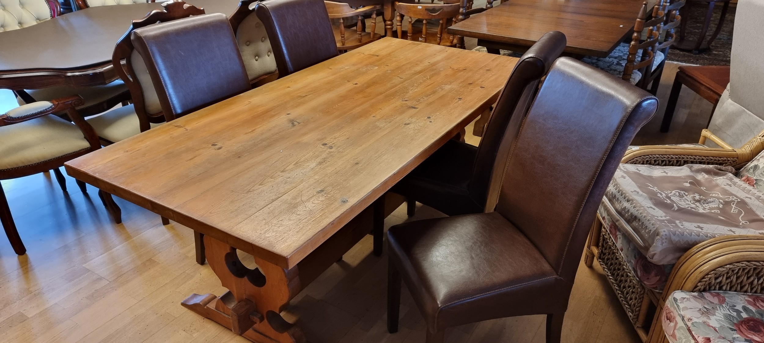 A pine trestle table 183 x 87 x 74 with four dining chairs.