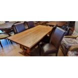 A pine trestle table 183 x 87 x 74 with four dining chairs.