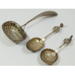 A 19th century Dutch silver sifter spoon, date letter 1841, and two later Dutch silver christening