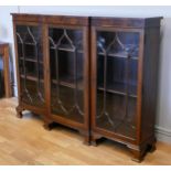 An Edwardian astragal breakfront bookcase, having four glazed doors, enclosed shelving and raised on