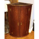 A George III oak corner cupboard, the plain doors opening to reveal three shelves, Chinoiserie brass