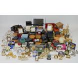 A large collection of miniature novelty clocks, together with a selection of traveling alarm clocks.