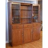 Ercol - elm display cabinet, two glazed doors flanking glass shelves with lighting above, the base