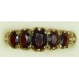 A vintage 9ct gold five stone garnet ring, London 1971, carved claw setting, R, 4.3gm