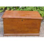A stained pine Victorian blanket box, interior fitted with candle tray, having original carry