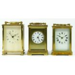 Two French brass cased 8 day carriage clocks, together with an English 8 day example. (3)