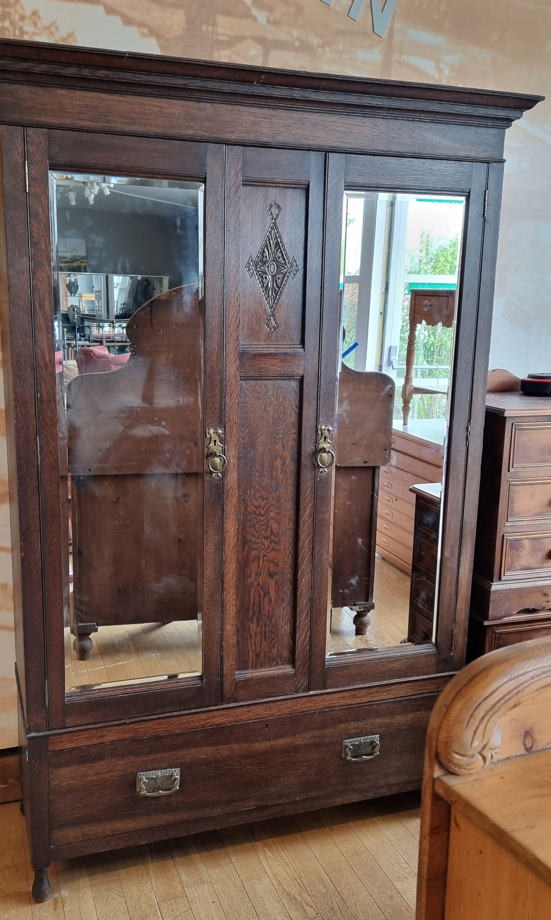 An Edwardian oak two mirror door wardrobe by Bernard H. Rose, Woodseats, cabinet makers, single