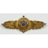 A Victorian 9ct gold panel brooch, set with a sapphire boarded by half pearls