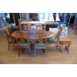 A Parker Knoll teak extending dining table and six matching dining chairs together with a mid 20th