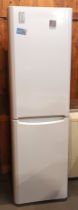 An Indesit free standing fridge/freezer 200cm tall, 58cm wide, together with a Novia Scotia chest