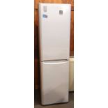 An Indesit free standing fridge/freezer 200cm tall, 58cm wide, together with a Novia Scotia chest