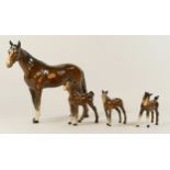 A collection of ceramics to include four Beswick horses, a four piece Beswick "cottage" tea and