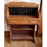 An Edwardian oak roll top small desk, the tambour opening to reveal a fitted interior, frieze