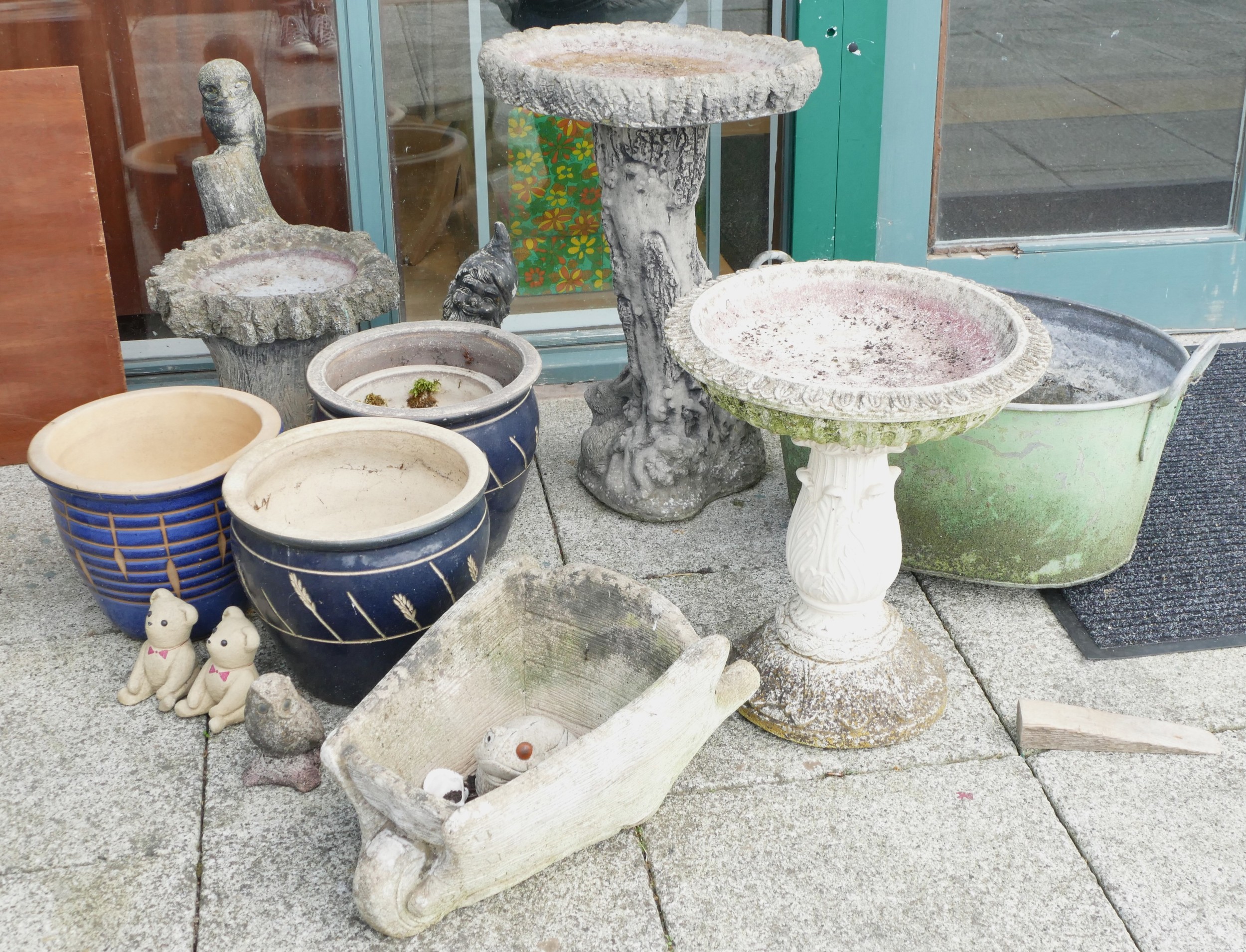 A collection of garden urns and ornaments to include glazed stoneware planters, composition bird