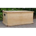A Victorian stripped pine blanket box, hinged paneled lid opening to reveal two fitted candle