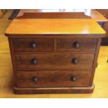 A Victorian mahogany chest of drawers, having rear upstand, two short and two long graduated drawers