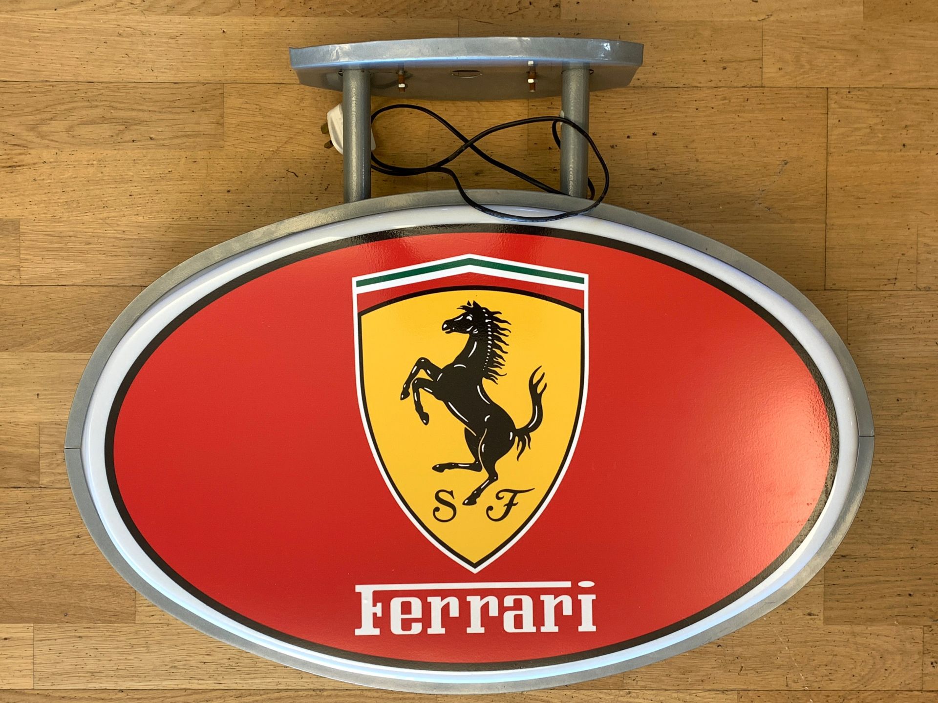 A Ferrari illuminated shop display sign, roof hanging, metal frame with plastic shell, depicting the