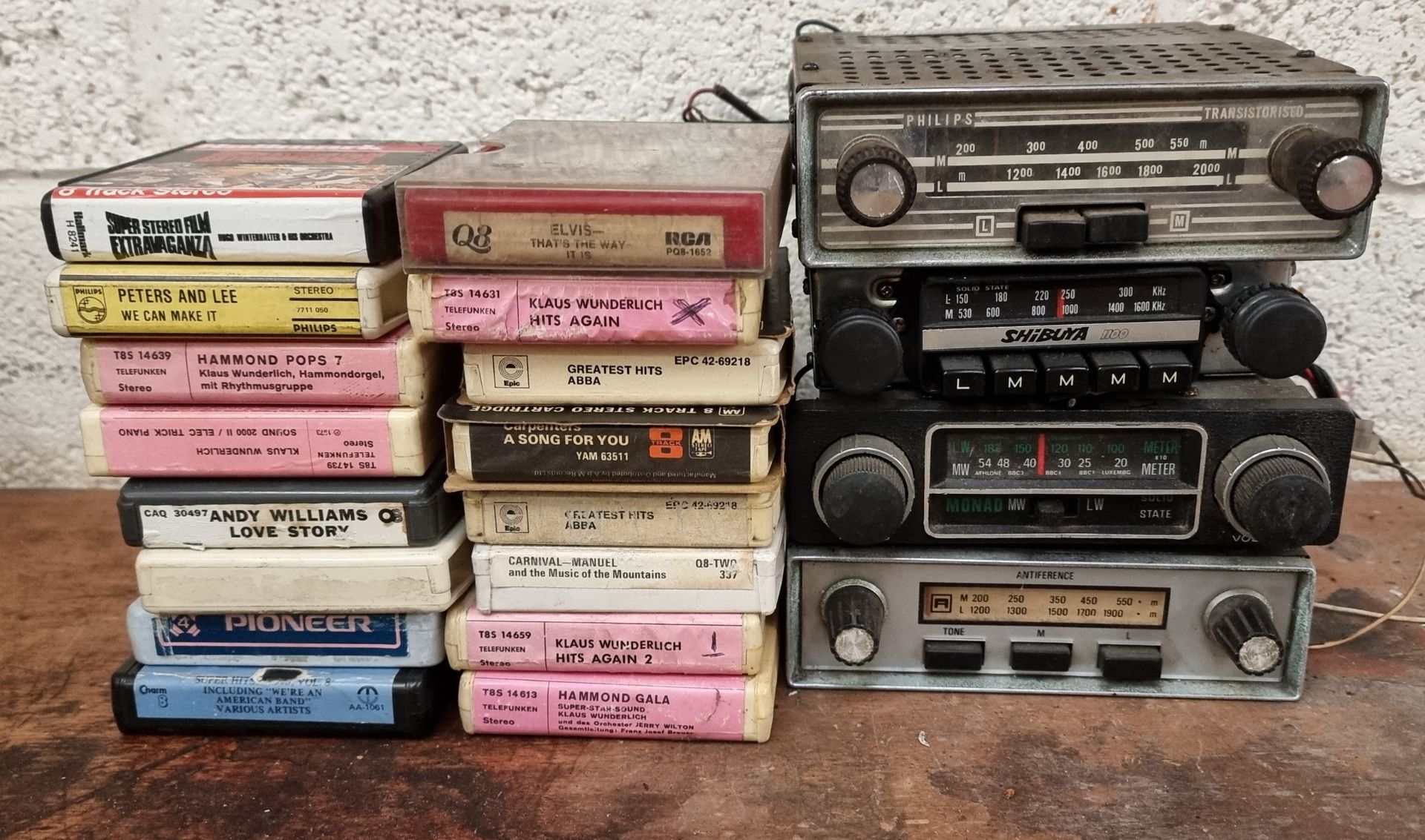 Four car radios and various 8 track cassettes.