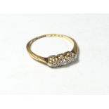 An 18ct gold three stone old cut brilliant diamond ring, approximately 0.20cts, L, 1.6gm, shank