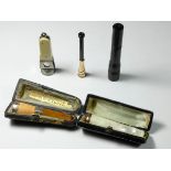 A 9ct gold mounted adjustable cigarette hold, Bakelite case, a mother of pearl cigarette holder,