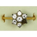 An 18ct gold and brilliant cut diamond cluster ring, one setting vacant, each stone approximately
